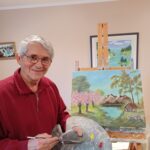 Artist painting in studio