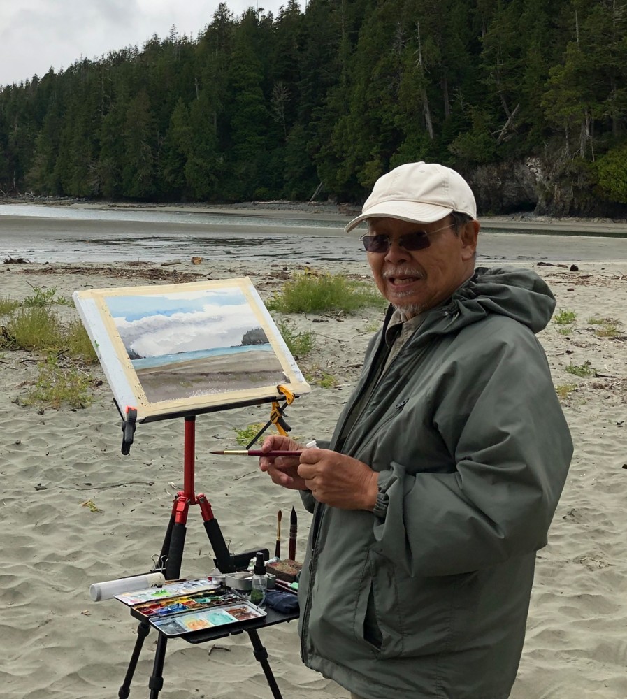 artist painting on the beach